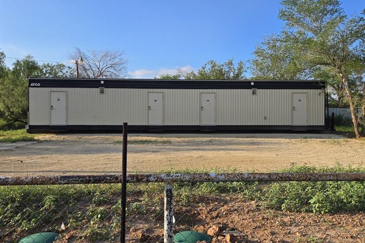 A mancamp building with four separate outside doors